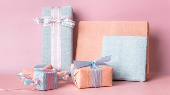 pastel pink and blue gifts against a pink wall