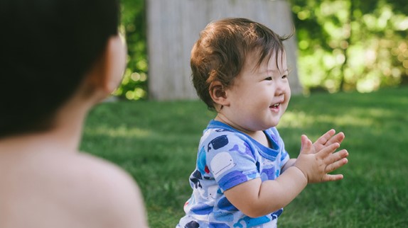 when should babies wave, clap and point?