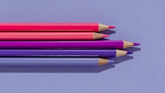 moms' politics and parenting styles, pink and purple colored pencils lined up on a purple background