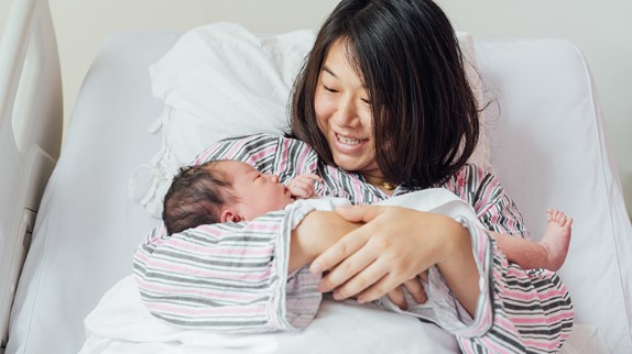 mom with newborn baby in the hospital, postpartum recovery