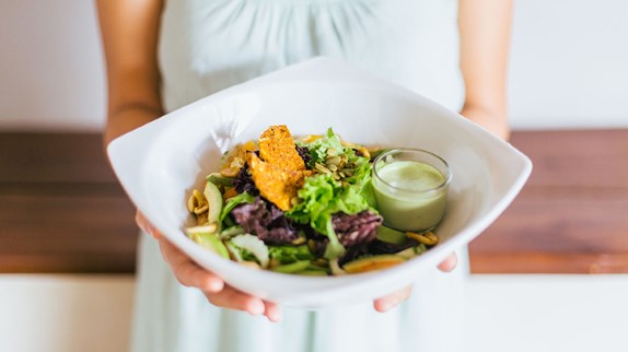 the prepregnancy diet, woman holding a healthy salad