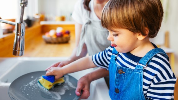 how to avoid spoiling your toddler, mother and toddler son doing dishes and cleaning